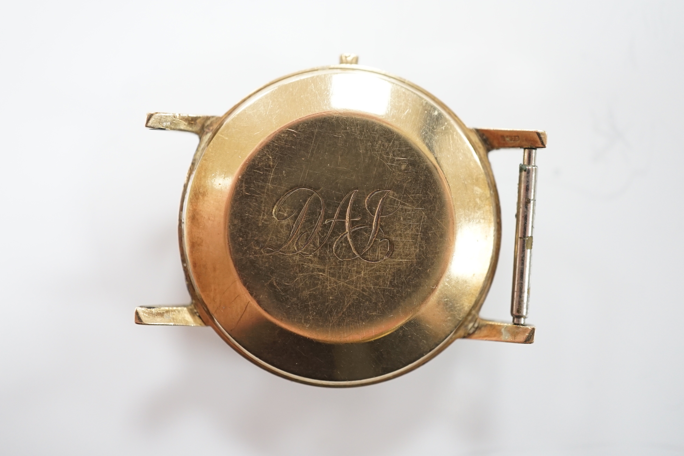 A gentleman's 9ct gold Omega automatic wrist watch, with date aperture, no strap or winding crown.